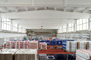 Spacious warehouse interior featuring organized shelves with various stacked pallets.